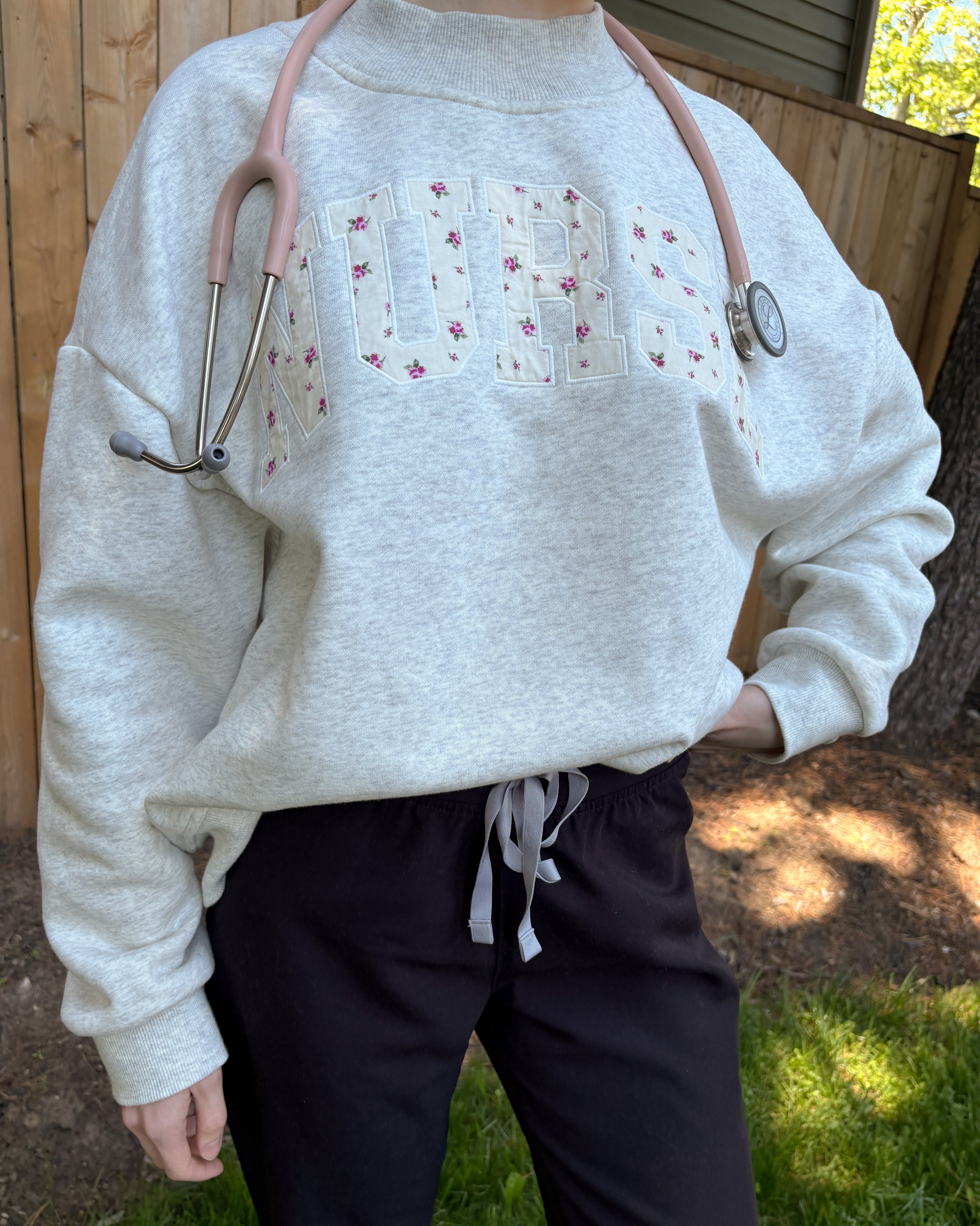 Mock neck with 'nurse' embroidery
