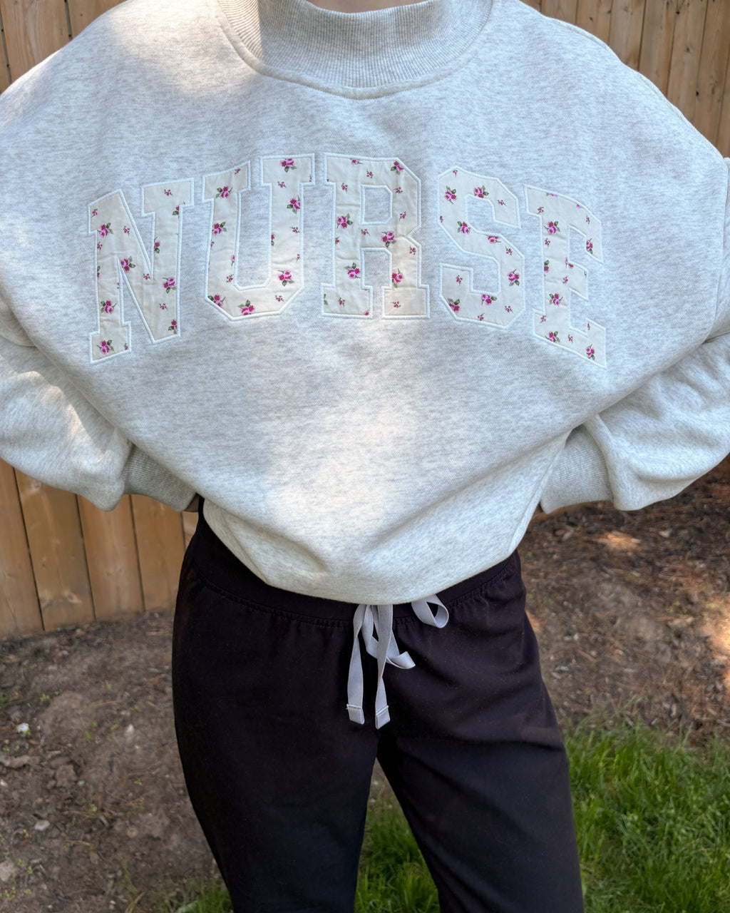Grey mock neck sweatshirt with floral appliqué embroidery 'nurse'